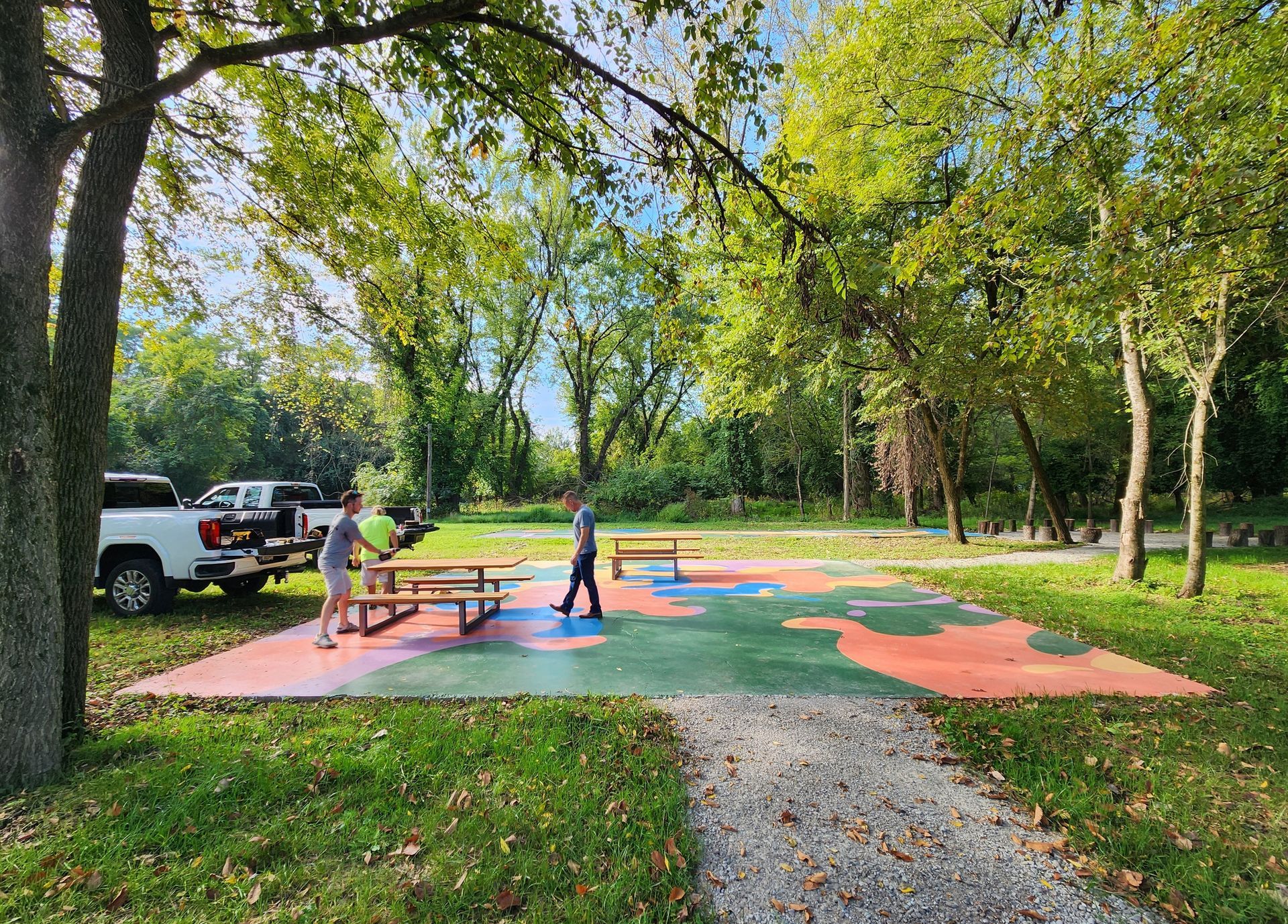 A group of people are playing in a park with a puzzle in the middle.