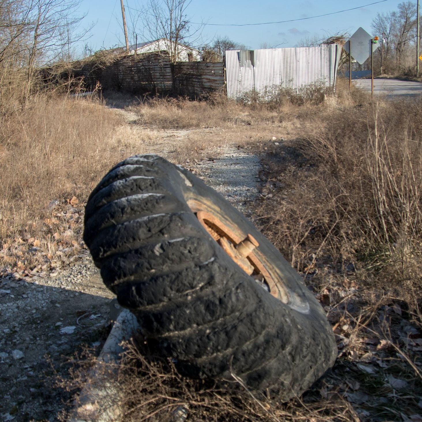 A tire with a hole in it is laying on the ground