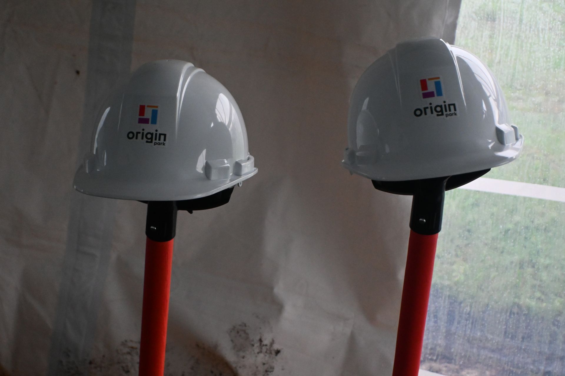 Two hard hats with the word origin on them