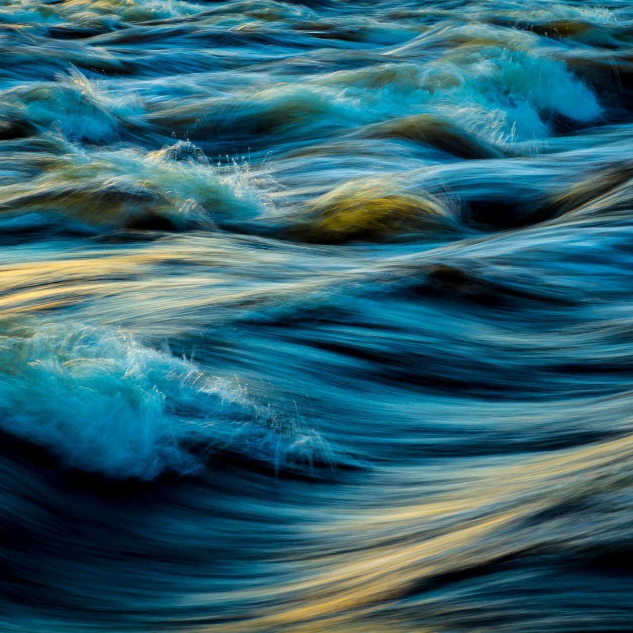 A close up of a river with waves coming in and out of it.