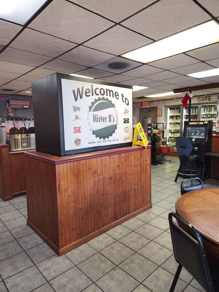 A restaurant with a welcome sign on the counter