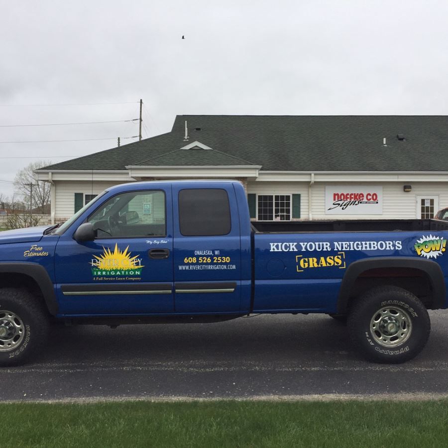 A Blue Truck Says Kick Your Neighbors Grass on The Side | Onalaska, WI | River City Irrigation