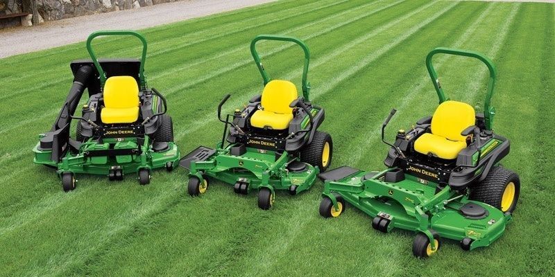 Three John Deere Lawn Mowers Are Sitting on Top of A Lush Green Lawn | Onalaska, WI | River City Irrigation