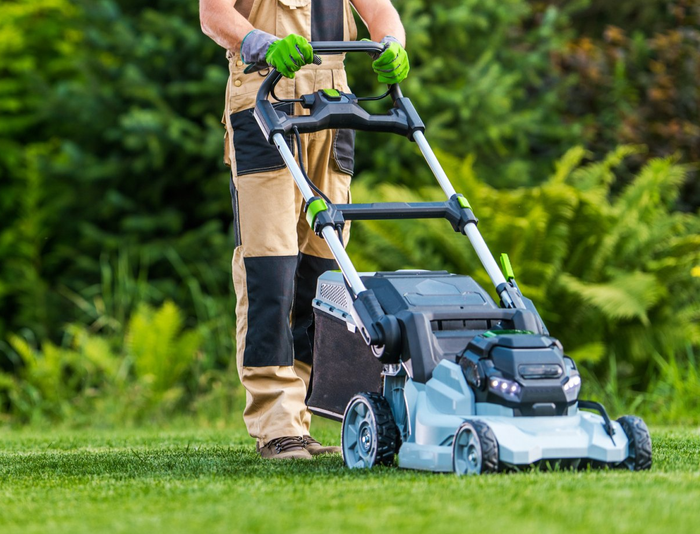 Gardener Trimming Grass Lawn Using Electric Cordless Mower - Durham, NC - The Silent Treatment