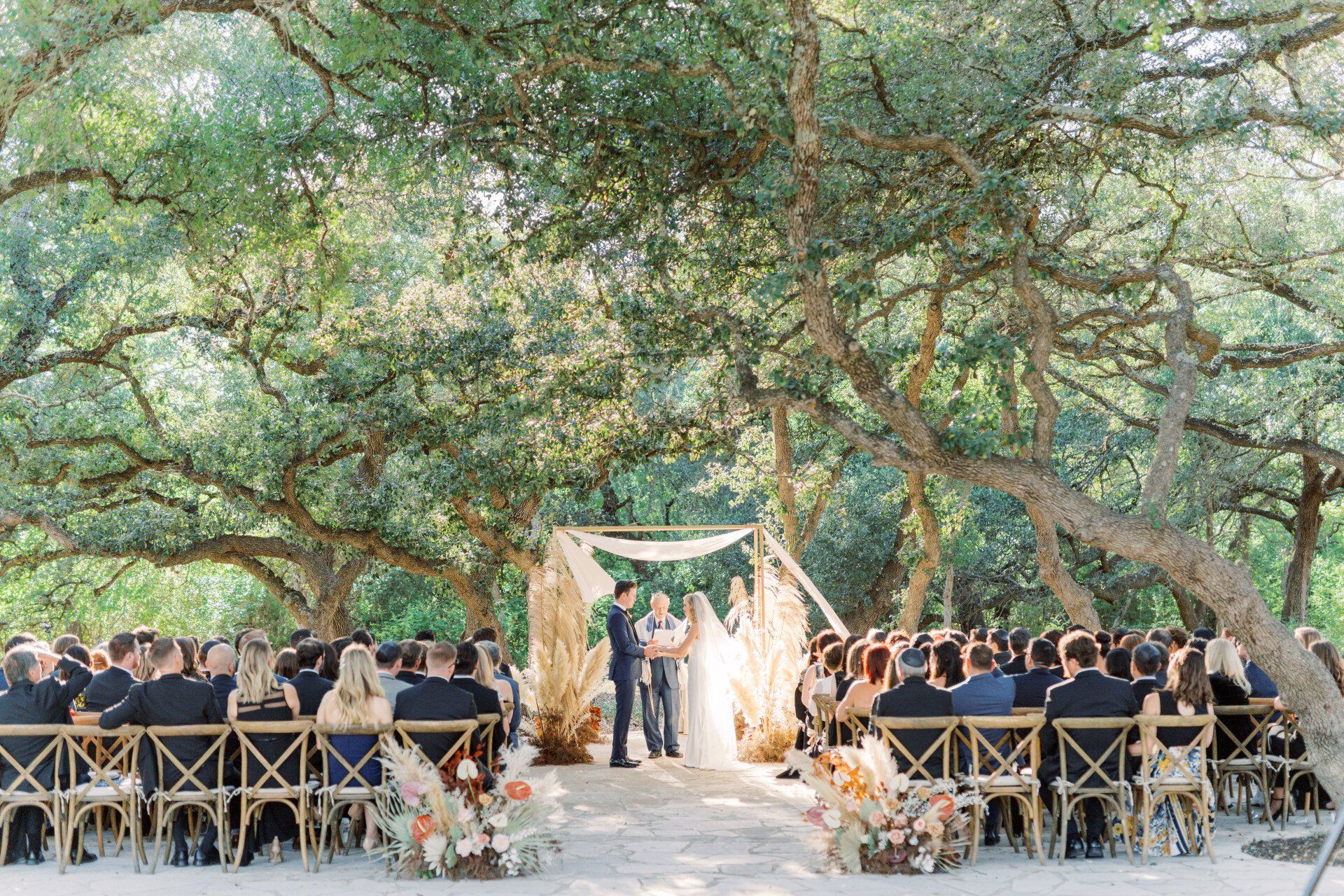 outdoor ceremony under the trees at The Addison Grove in Austin, Texas Hill Country Wedding Venue
