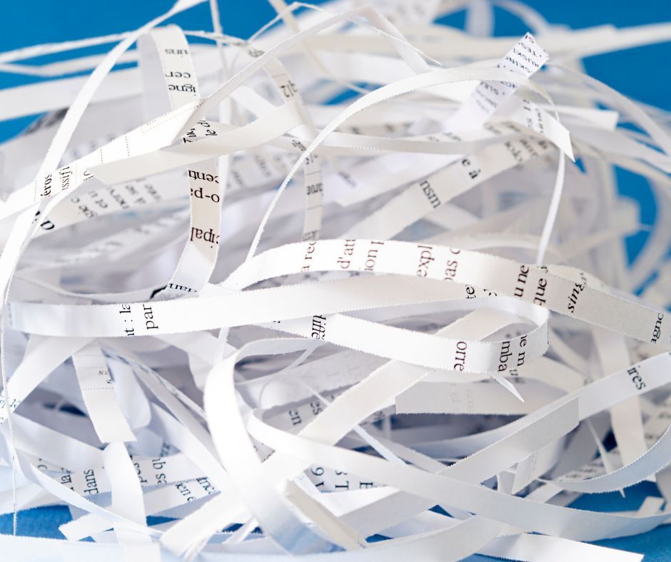 A pile of shredded paper on a blue surface