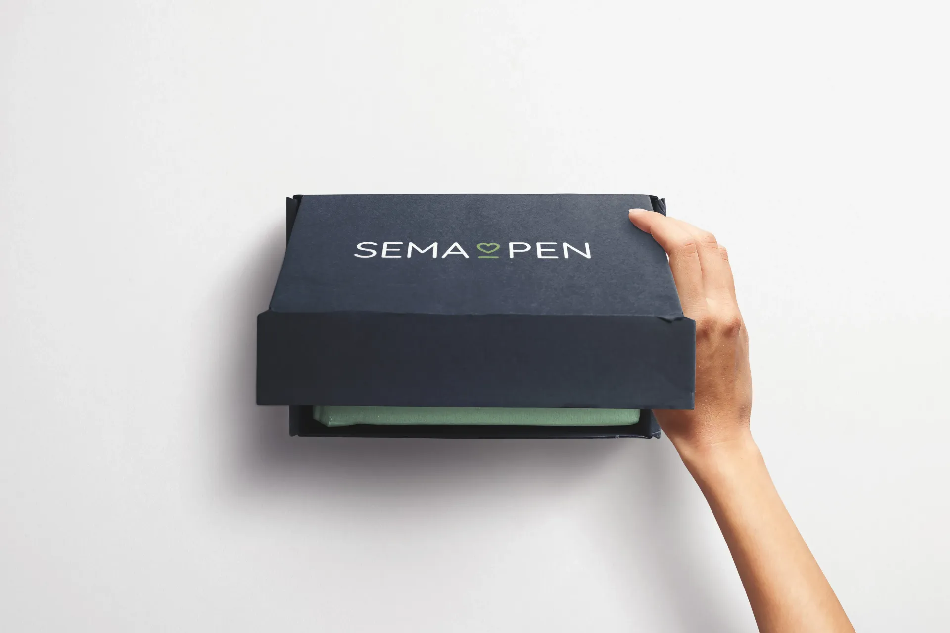 A person is holding a black box with the word pen on it.