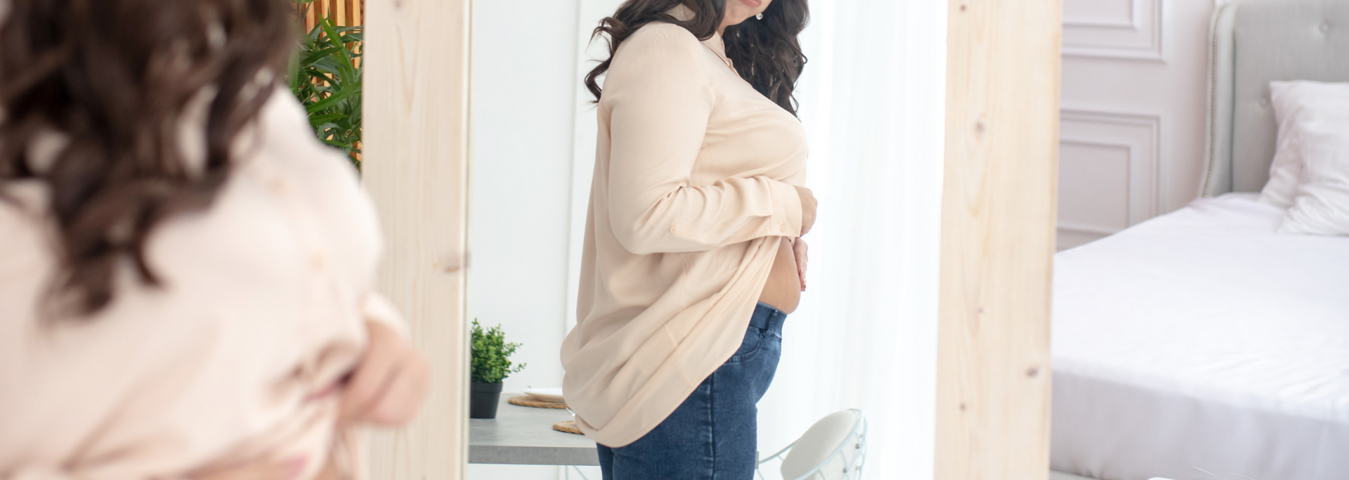 Picture of a person checking their skin in the mirror.