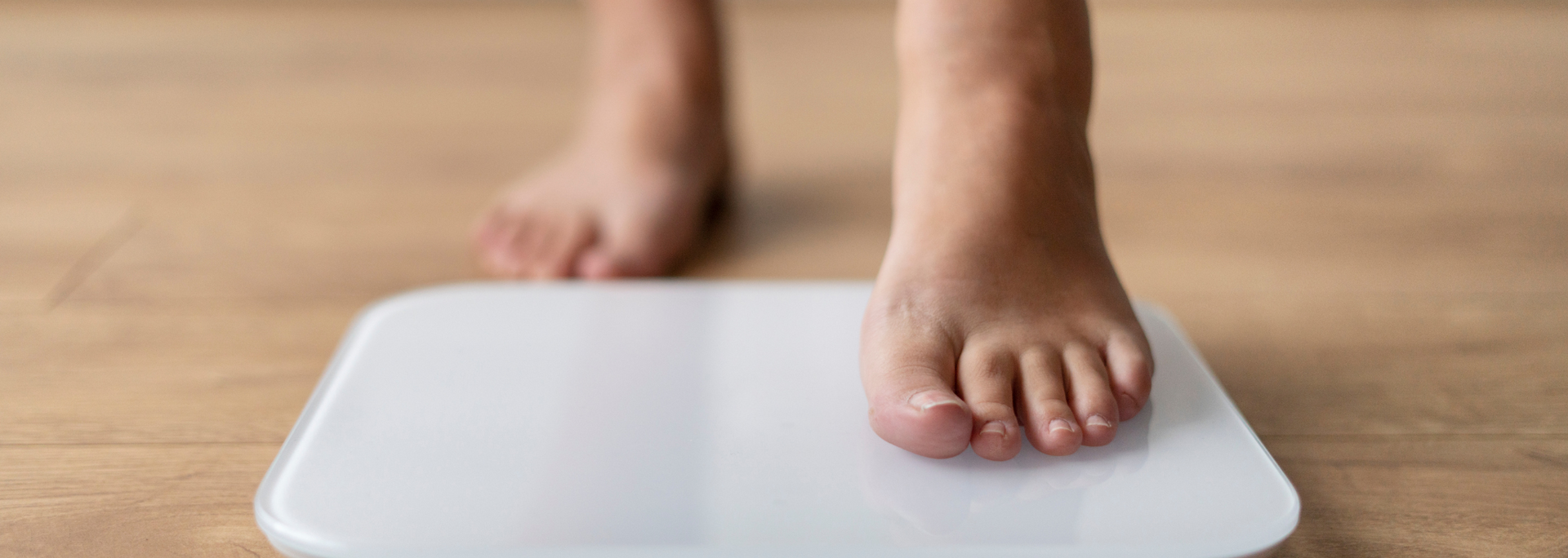Picture of a person stepping on a scale.