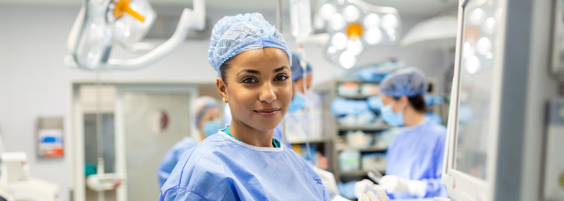 Picture of a friendly looking surgeon in surgical gear.