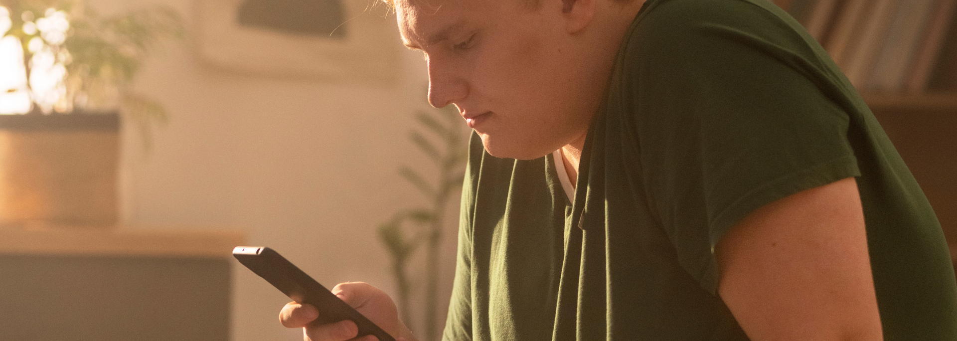 Picture of a person looking engaged while using a smartphone.