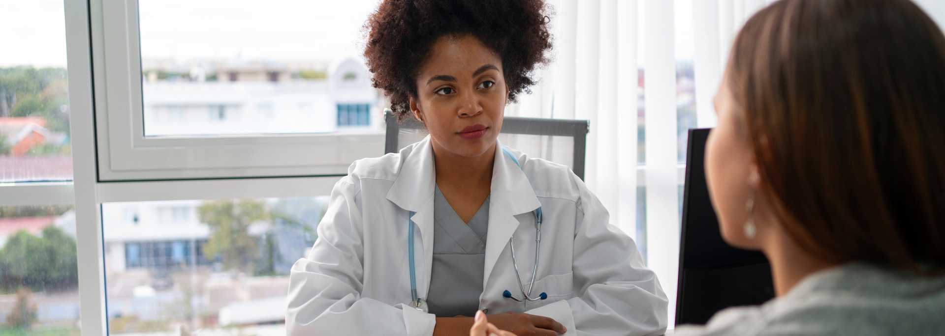 Picture of a person in consultation with a GP.