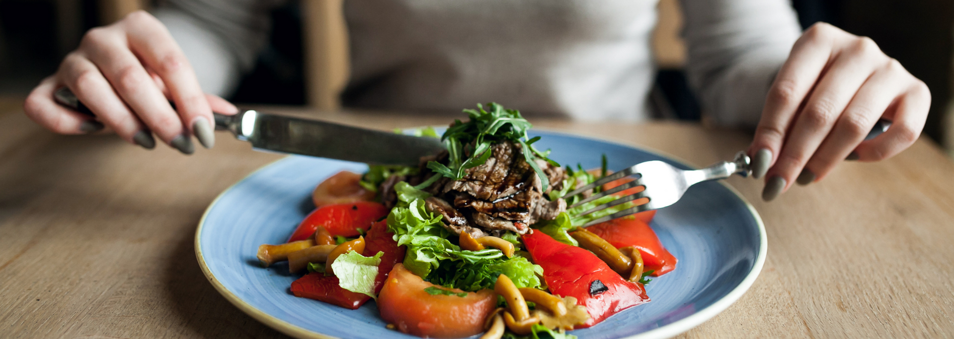 Picture of someone tucking into a balanced plate of healthy, nutritious food.
