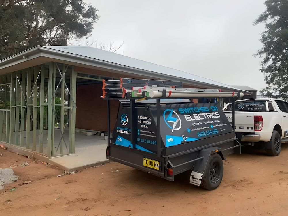 An Electrical Service Trailer and a White Pickup Truck Parked — Switched On Electrics in Wagga Wagga, NSW