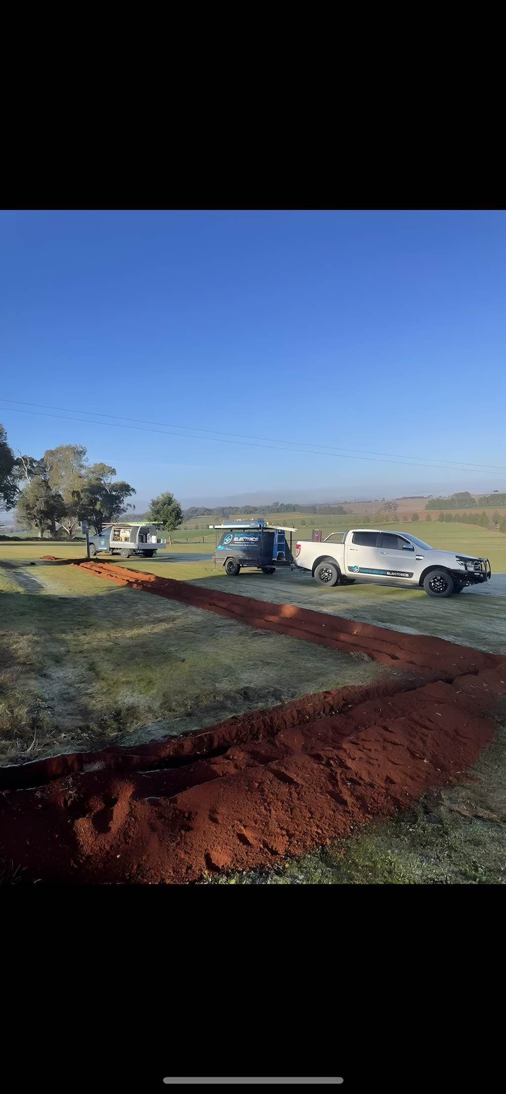 A Field With a Trench, a Truck, and a Vehicle Towing a Trailer — Switched On Electrics in Wagga Wagga, NSW