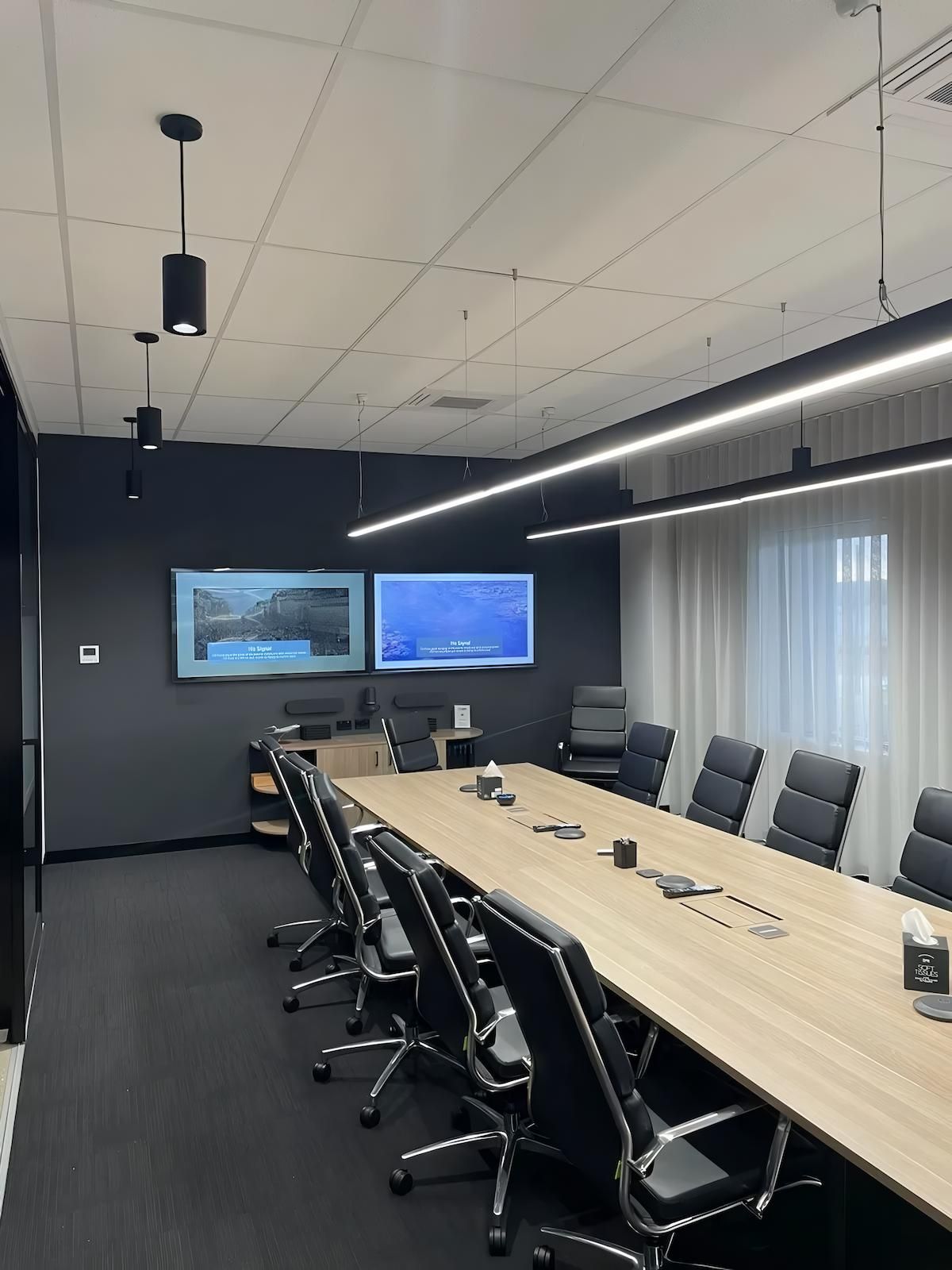 Conference Room With Long Table and Black Chairs — Switched On Electrics in Wagga Wagga, NSW
