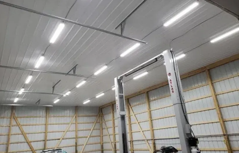 Garage Interior With Lift, Bright Overhead Lights on a White Ceiling — Switched On Electrics in Wagga Wagga, NSW