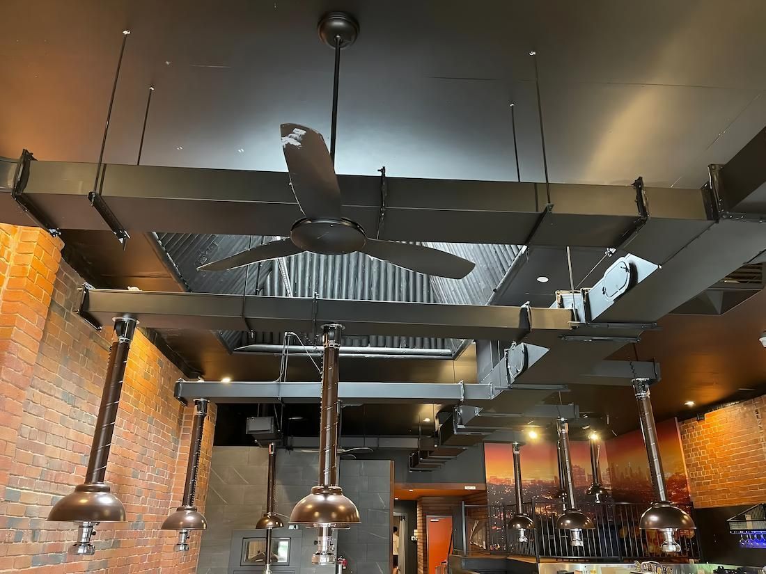 Black Ceiling With Dark Beams, a Ceiling Fan — Switched On Electrics in Wagga Wagga, NSW