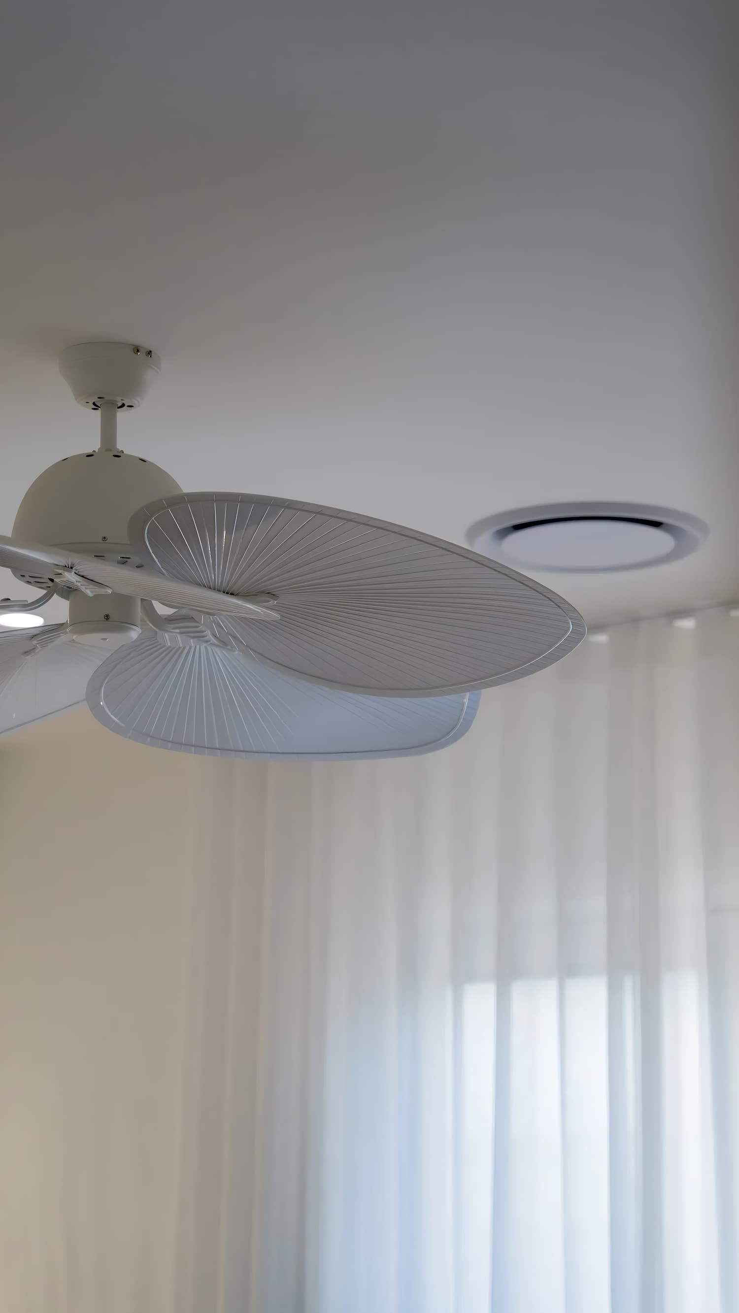 White Ceiling Fan With Patterned Blades, Mounted on a White Ceiling — Switched On Electrics in Wagga Wagga, NSW