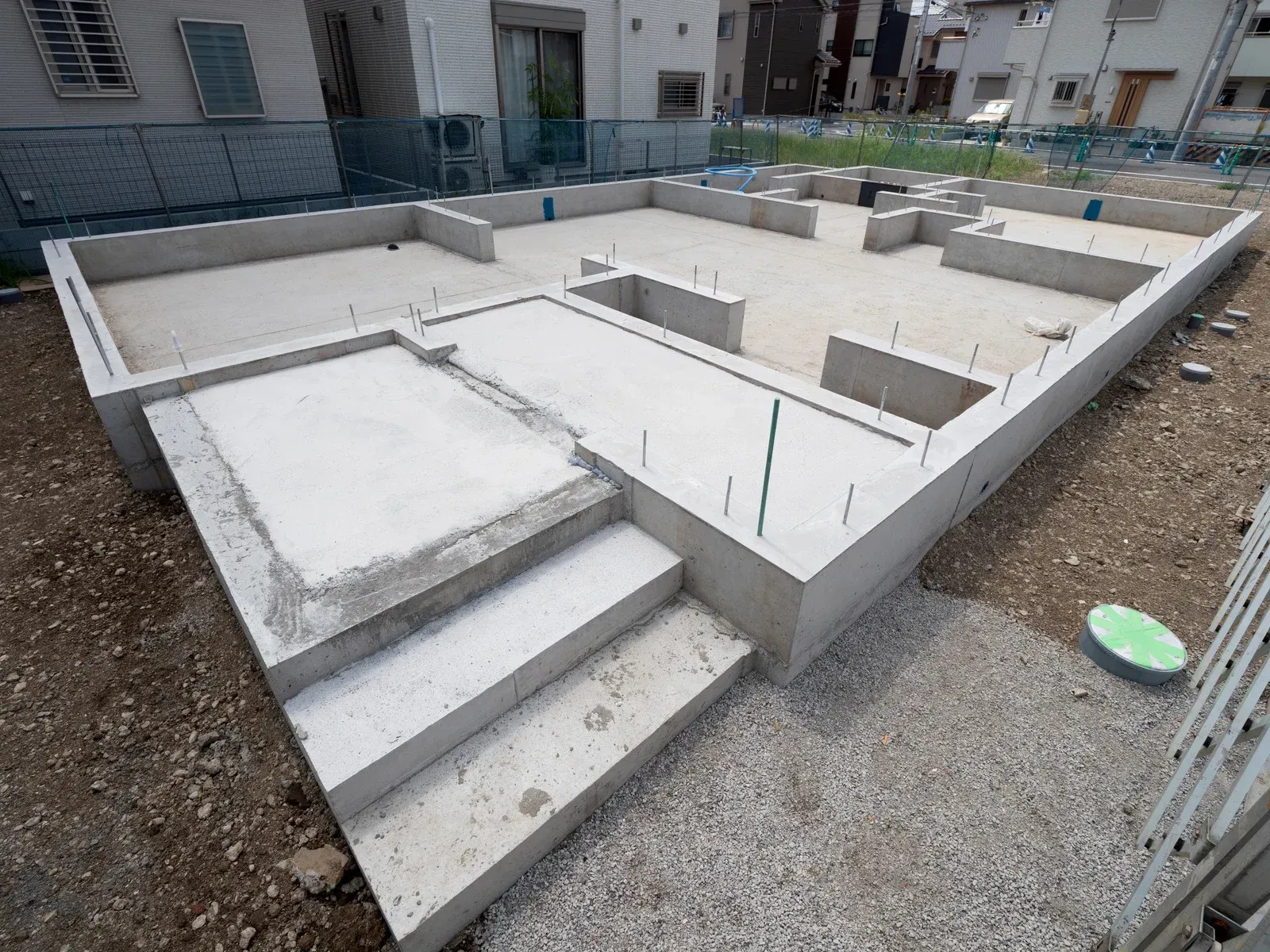 A concrete base of a house under construction with stairs.