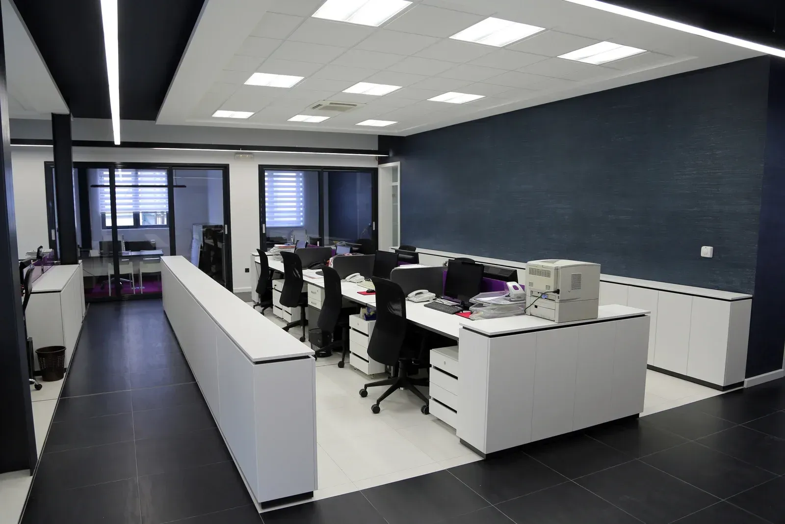 A large office with a lot of desks and chairs.
