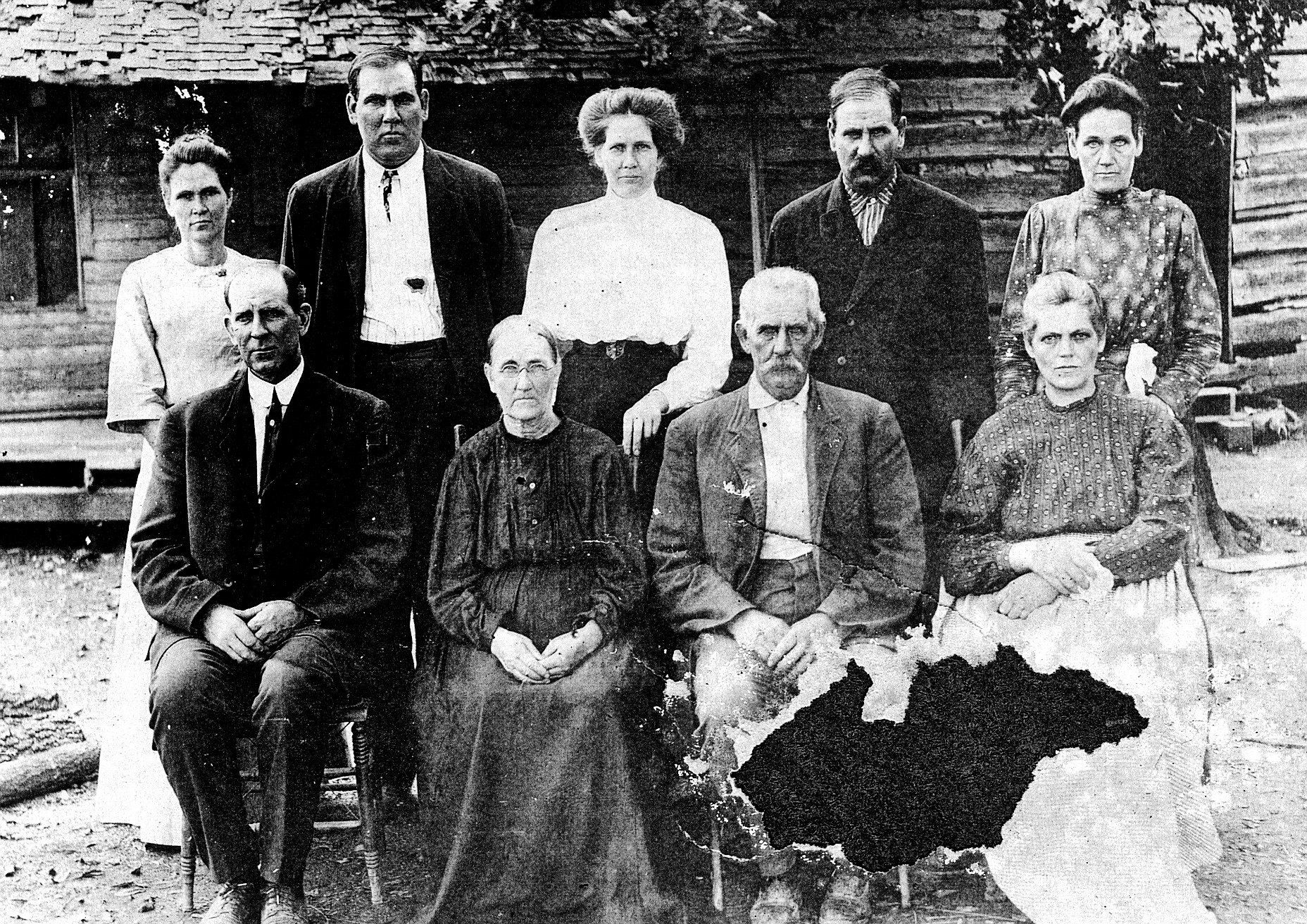 A black and white photo of a family posing for a picture