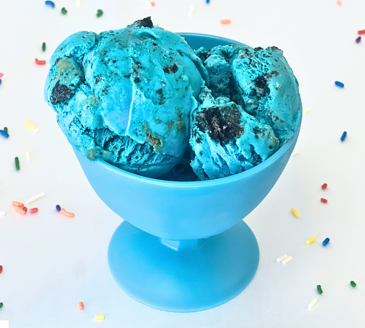 A blue bowl filled with blue ice cream and sprinkles