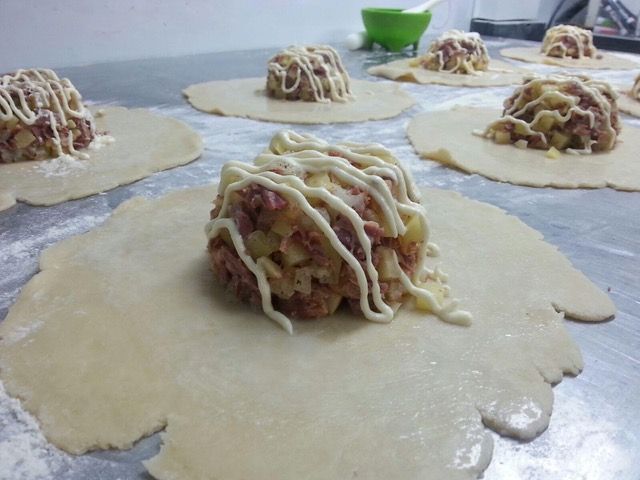 A bunch of food sitting on top of dough on a table