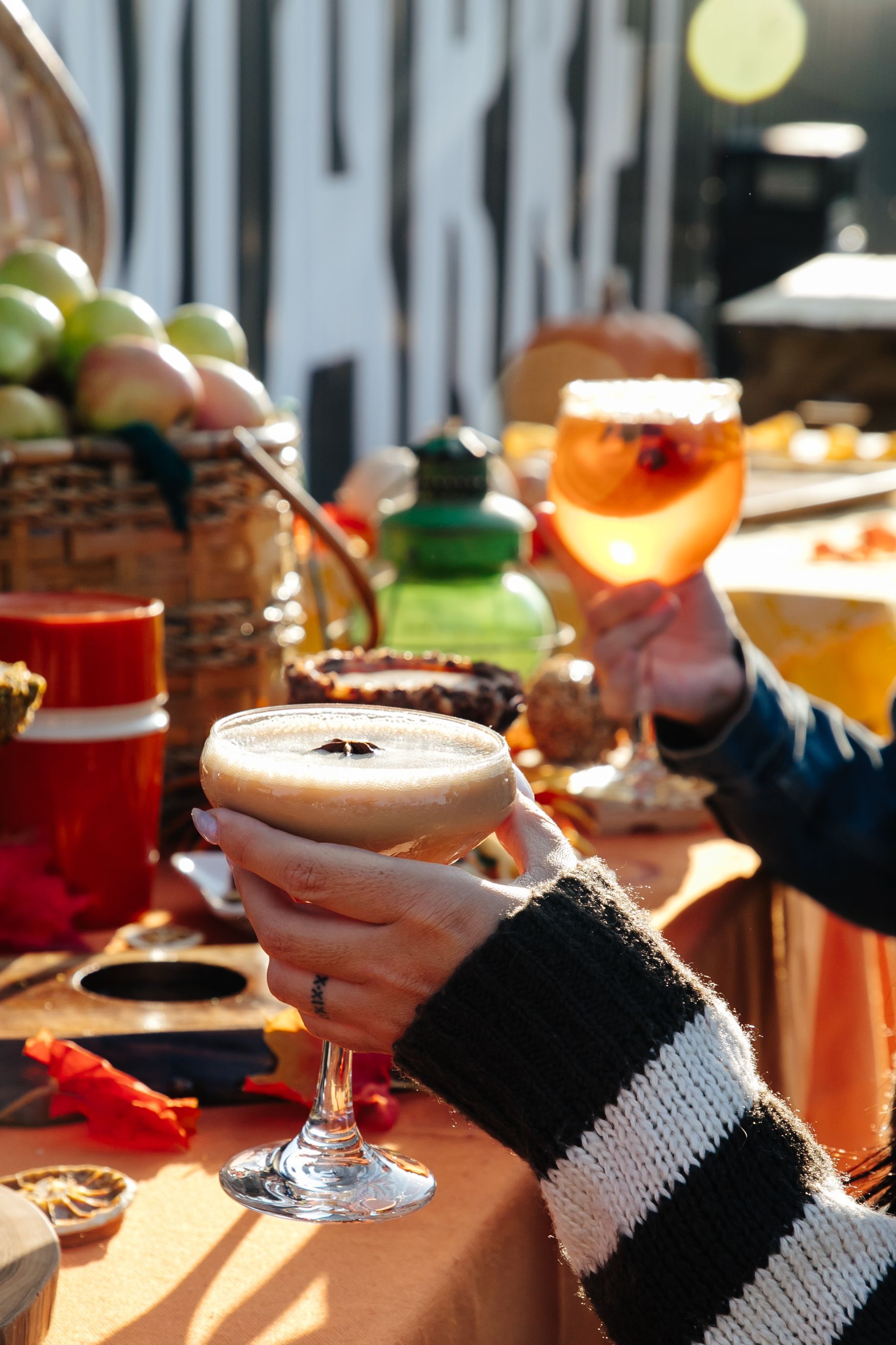 A person is holding a drink in their hand on a table at 14 Mill Market in Nixa Mo