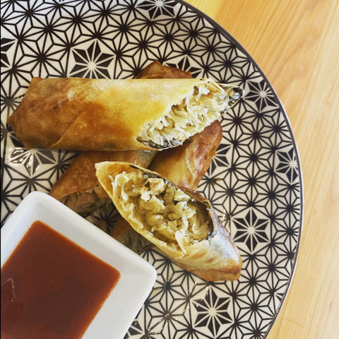 A plate of food with a dipping sauce on the side