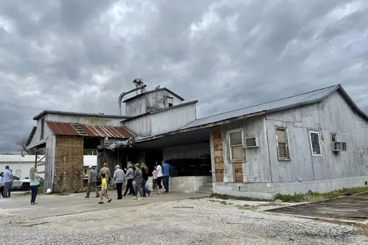 A group of people are standing in front of a large building.