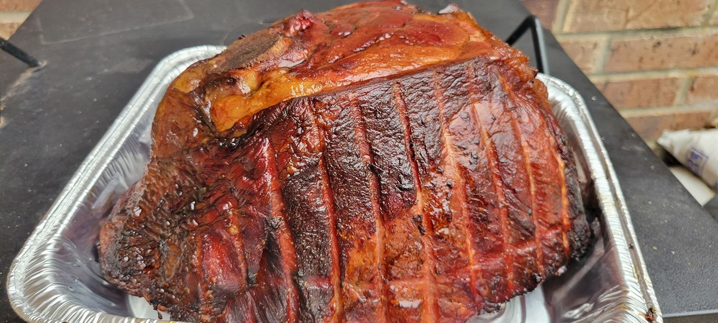 A large piece of meat is sitting on top of a foil tray.