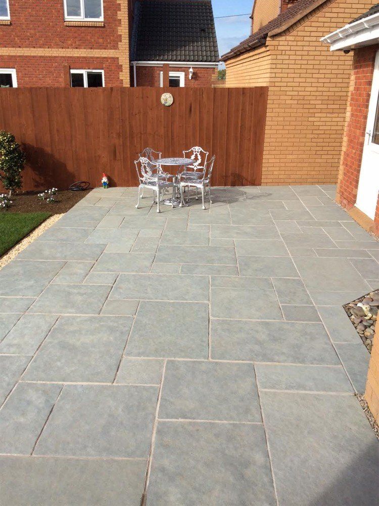 large limestone patio across whole width of garden