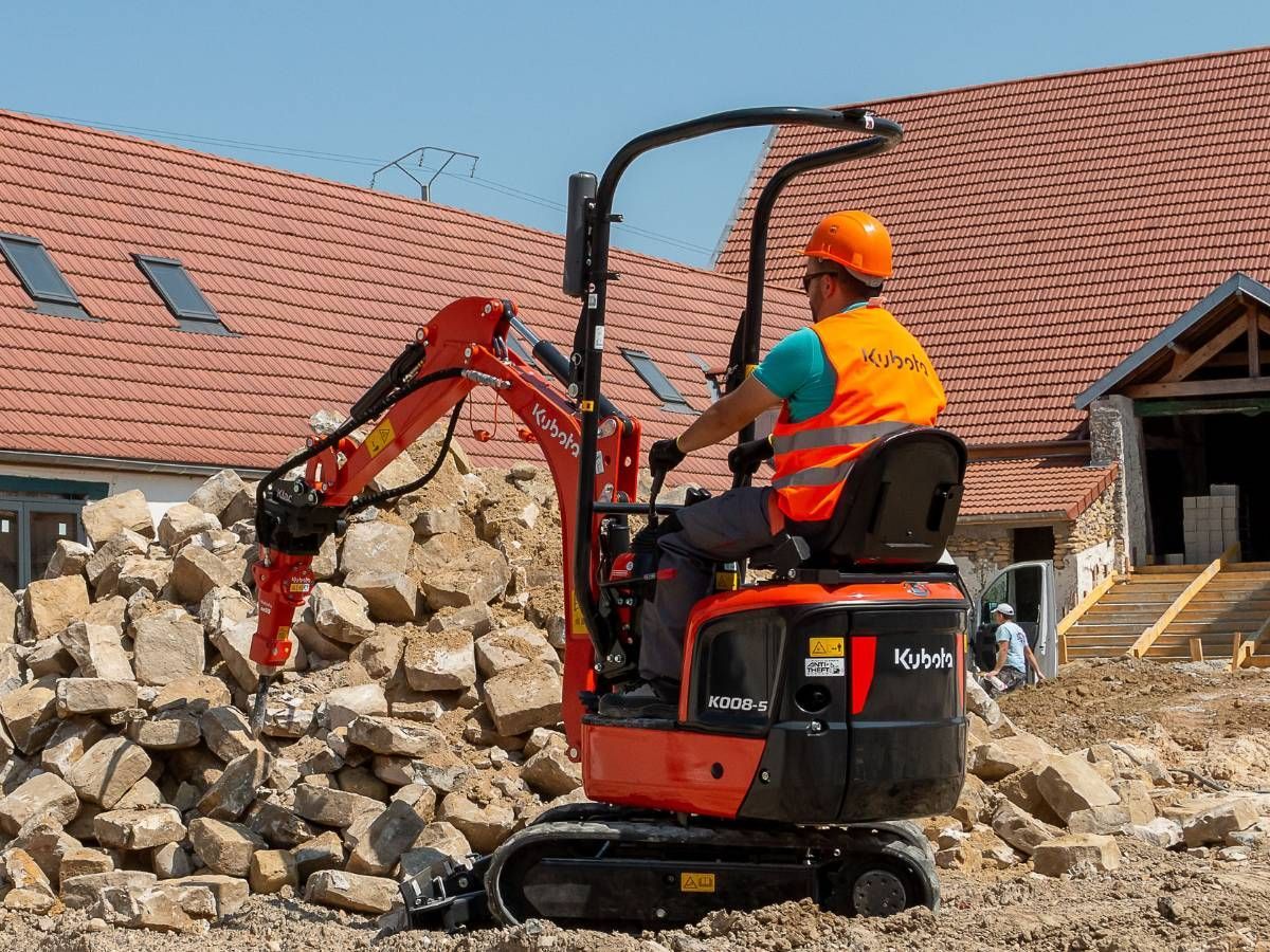 Micro digger and driver moving rubble in Sheffield