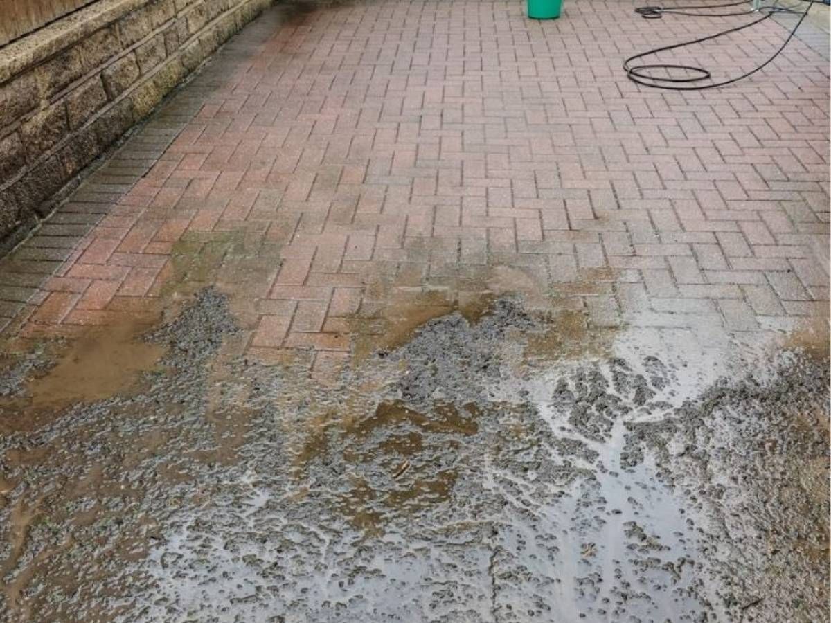 part way throug cleaning a block paving driveway