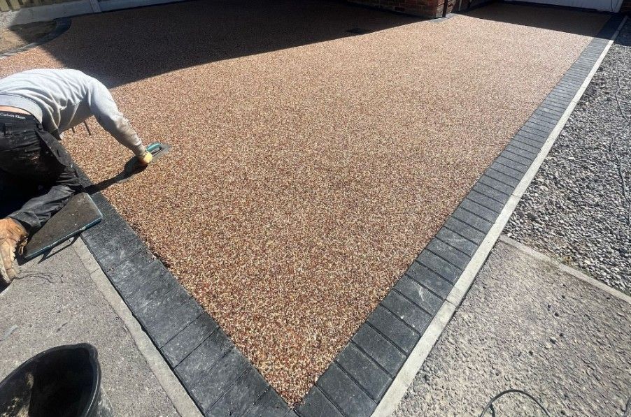 Buff resin driveway with block paving edging