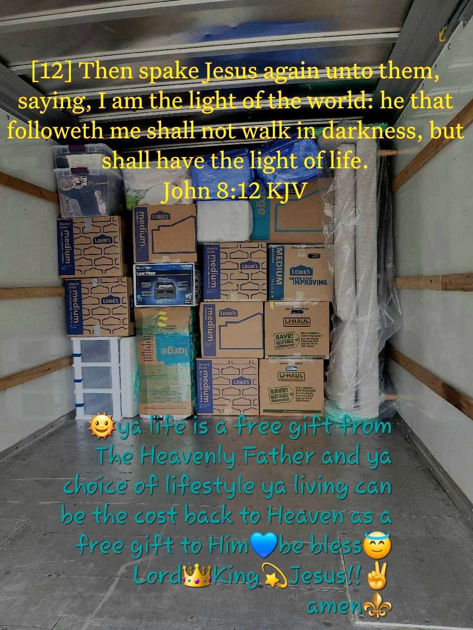 Boxes stacked inside a truck, with text from John 8:12 and other religious sentiments.