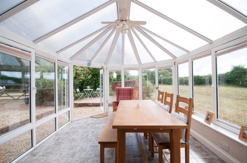 Big conservatory with dining table, chairs and bench