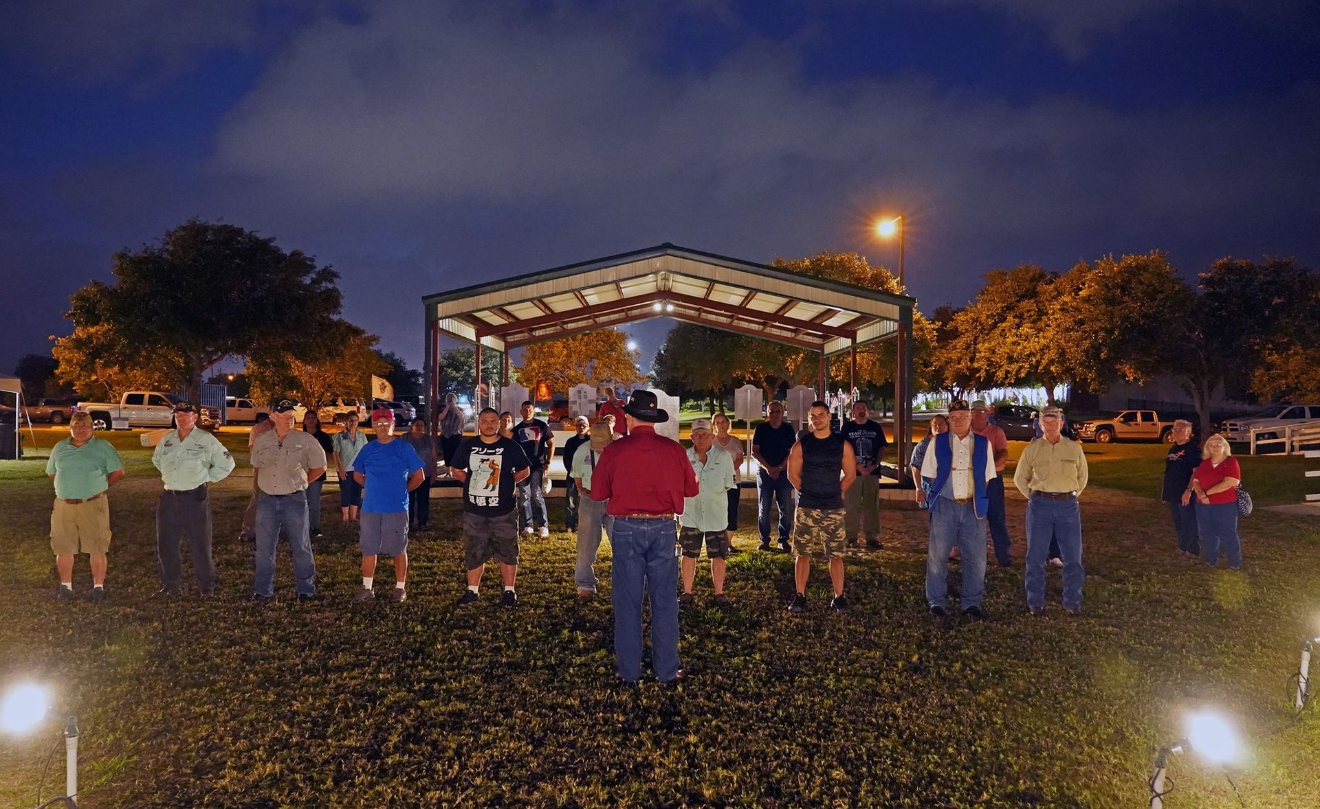 A group of people standing in a field at night