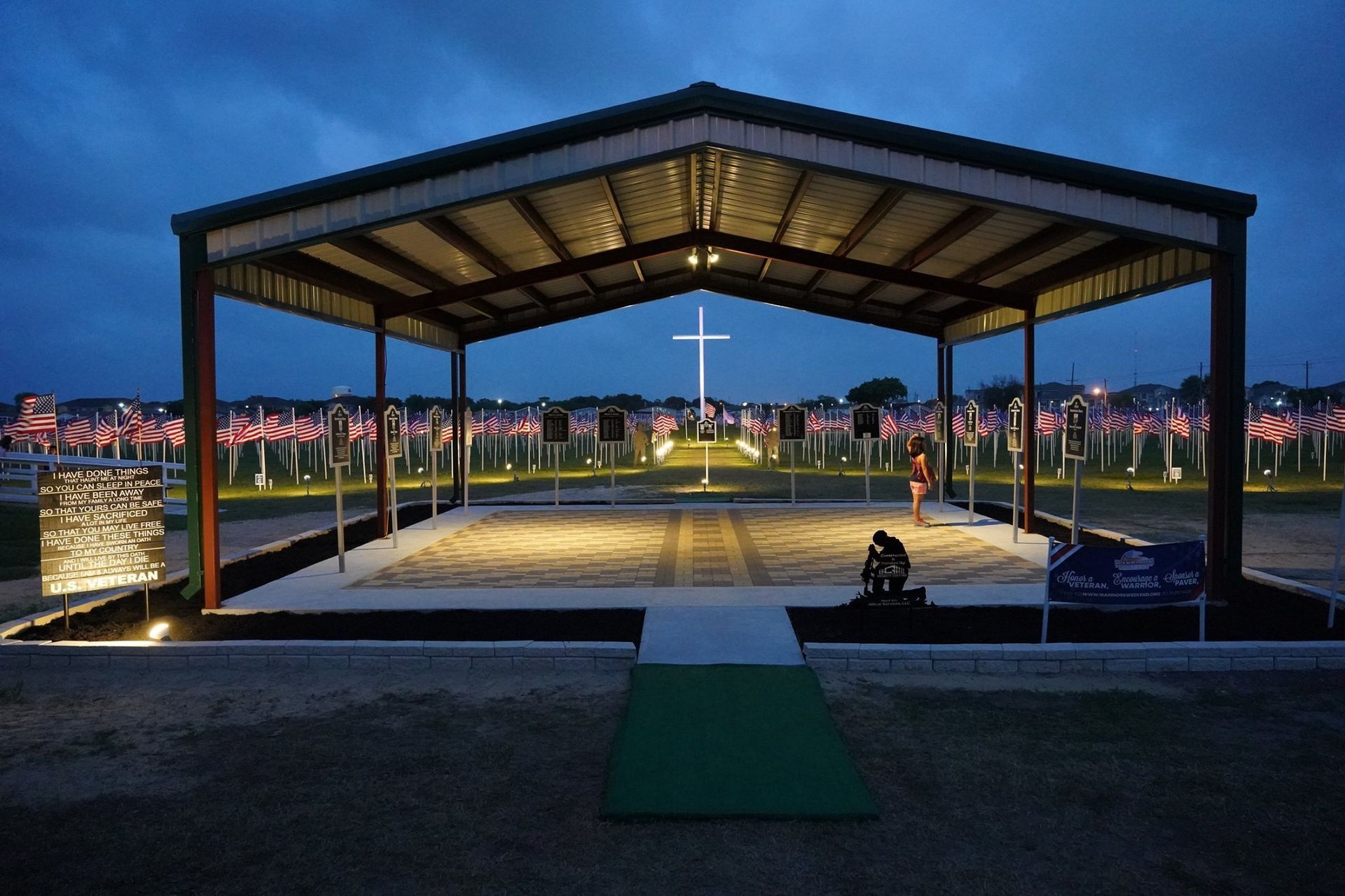 A large covered area with a lot of lights on it at night.