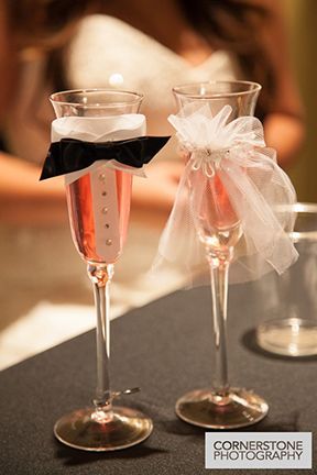 A Bride and Groom 's Champagne Flutes Are Decorated with Bows and Ribbons - Lee’s Summit, MO - Top Shelf Bartending Services, LLC