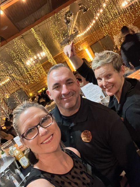 A Man and Two Women Are Posing for A Picture in A Restaurant - Lee’s Summit, MO - Top Shelf Bartending Services, LLC