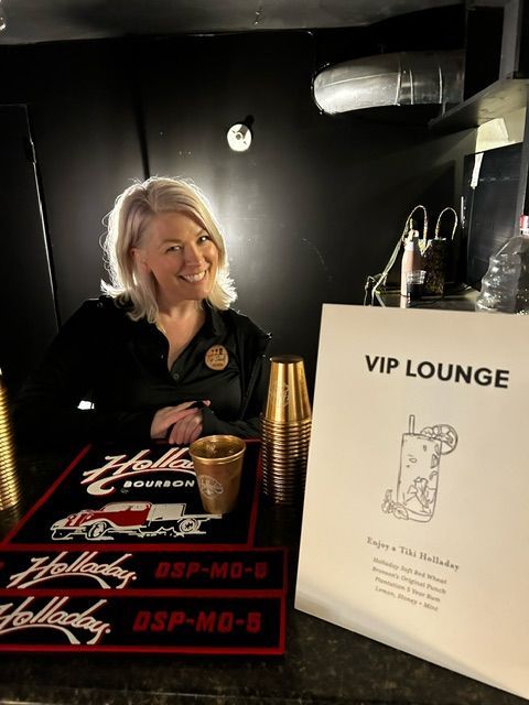 A Woman Sitting at A Bar with A Sign that Says Vip Lounge - Lee’s Summit, MO - Top Shelf Bartending Services, LLC