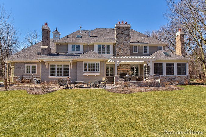 A large house with a lot of windows and chimneys