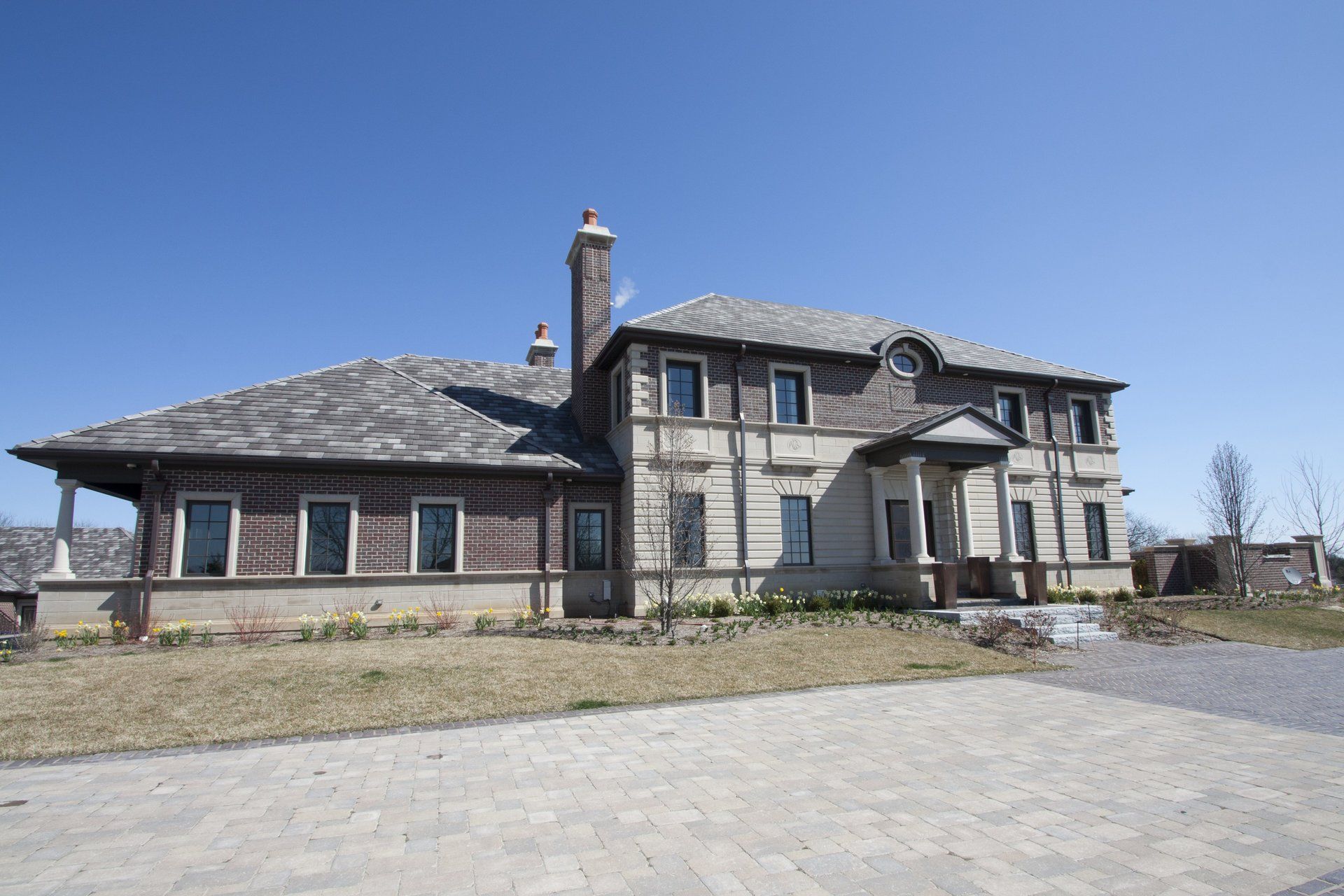 A large house with a lot of windows and a chimney on the roof