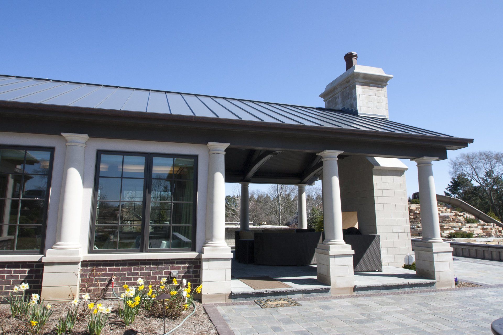 A house with a roof that has a chimney on it