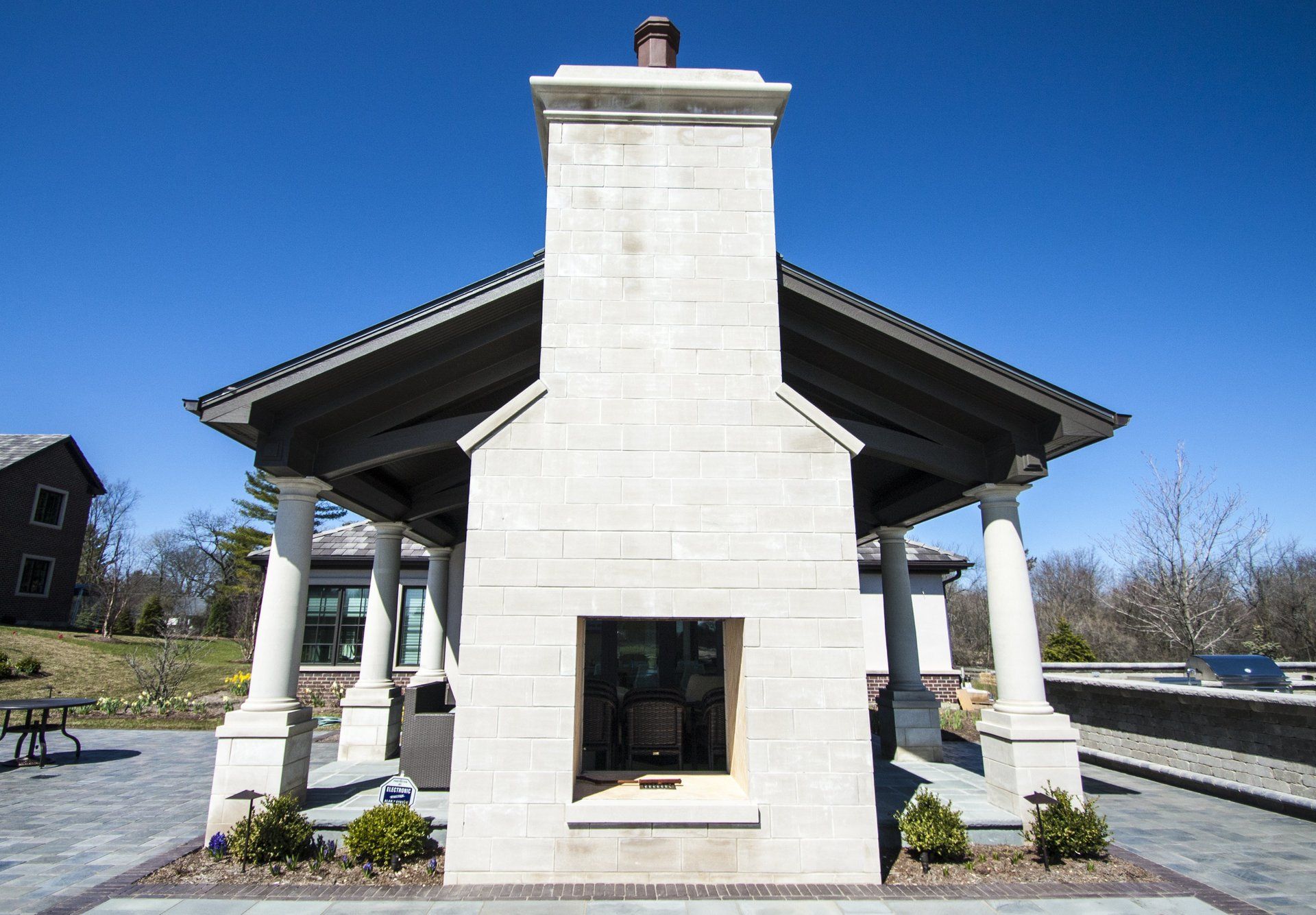 There is a large fireplace in the middle of a building.