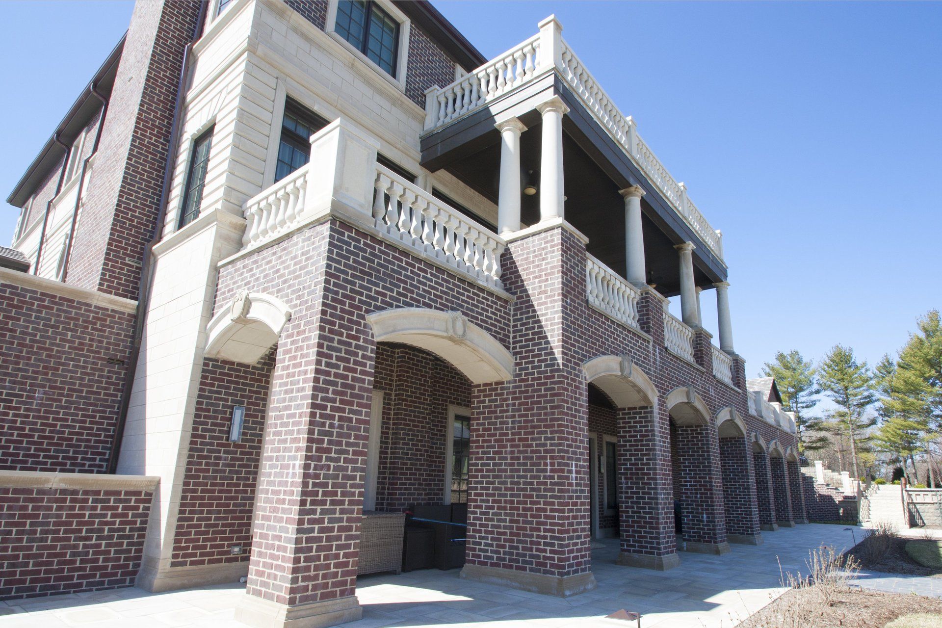 A large brick building with a balcony and columns