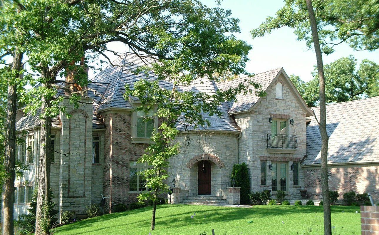 A large brick house with trees in front of it