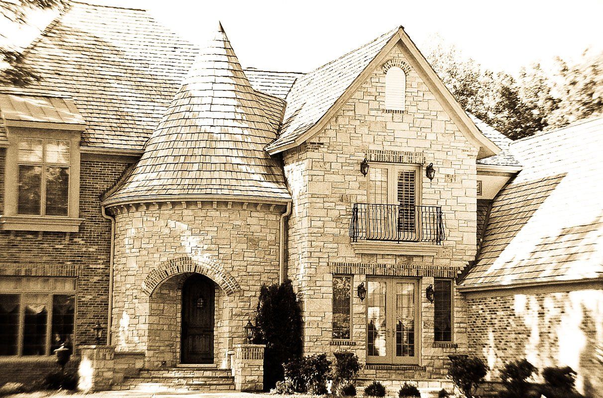 A black and white photo of a large brick house
